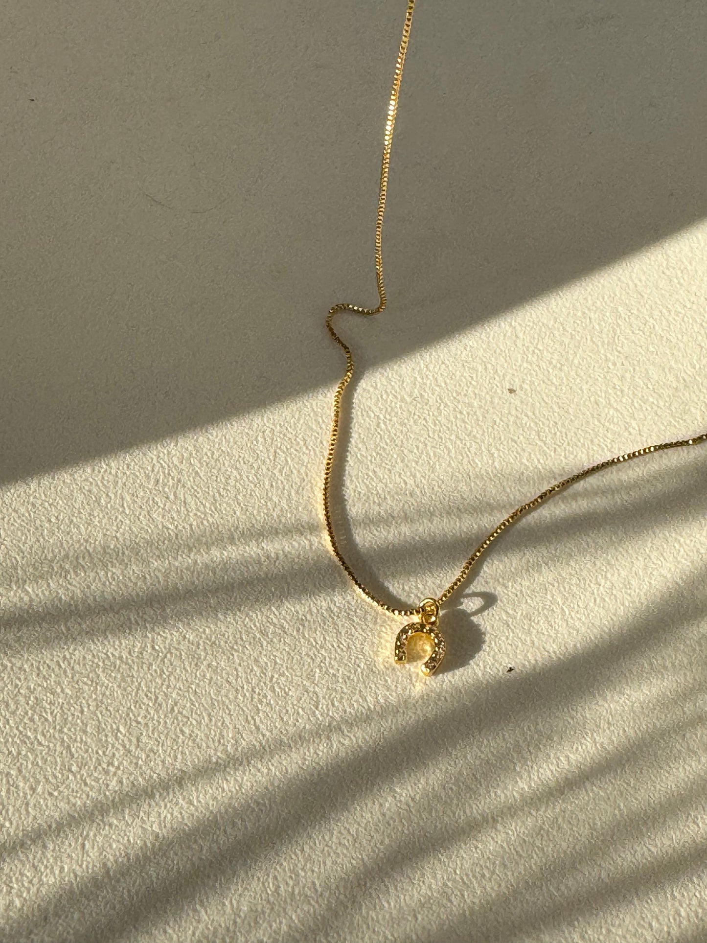 Horseshoe Mini Charm Necklace In Gold