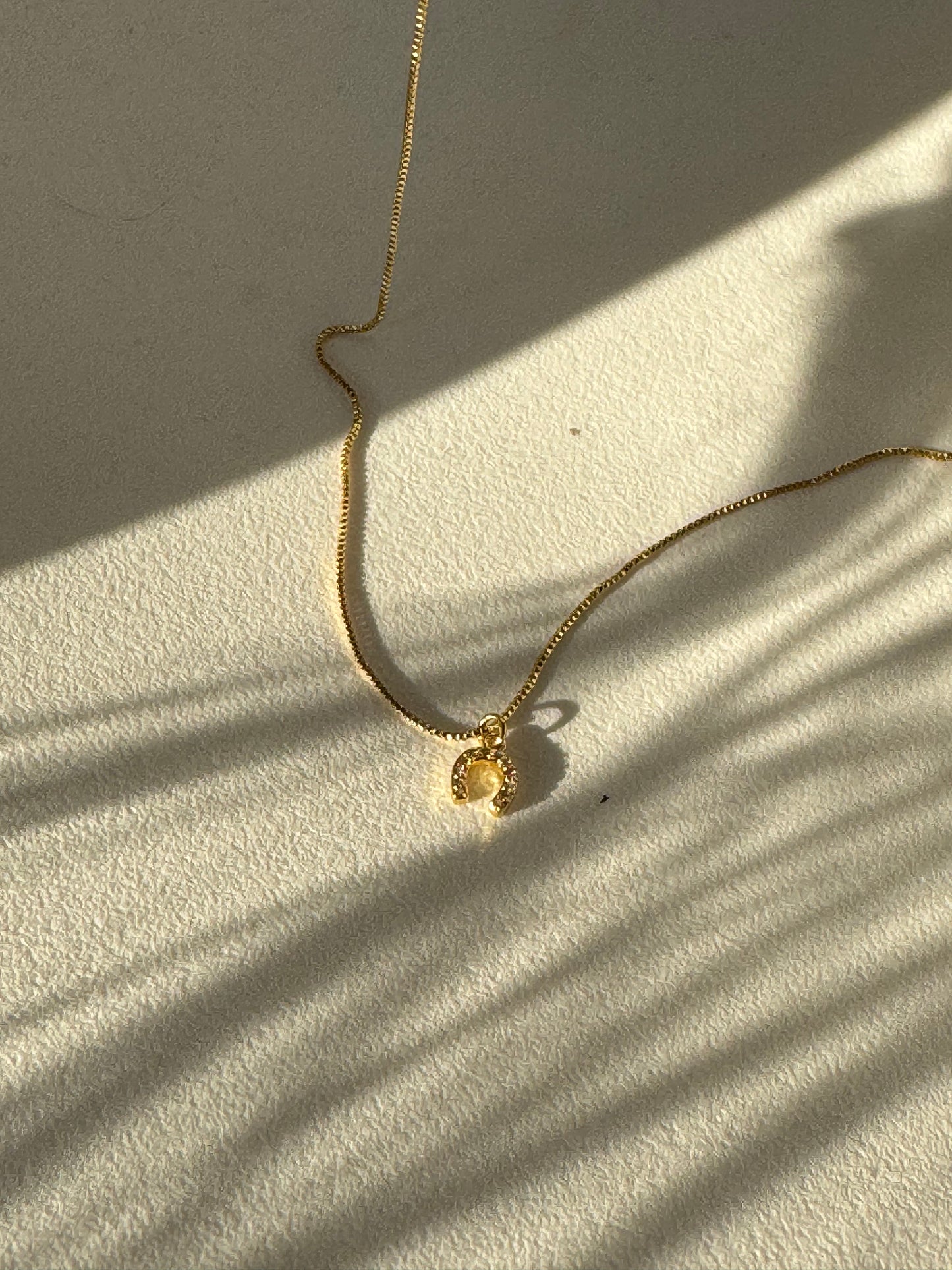 Horseshoe Mini Charm Necklace In Gold