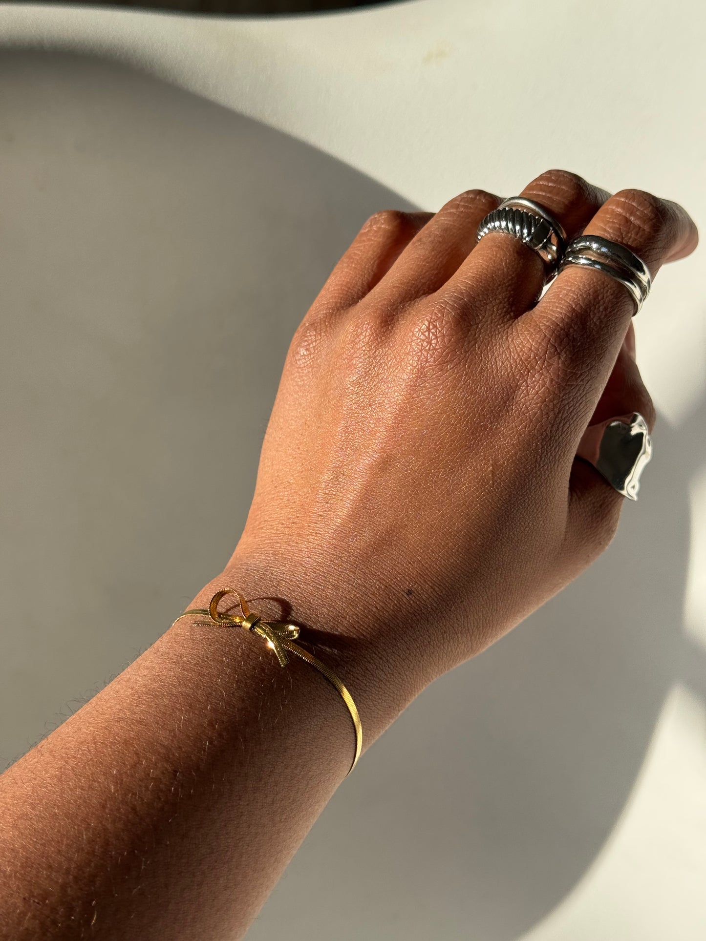 Kinsley Herringbone Stainless Steel Chain Bow Bracelet In Antique Gold