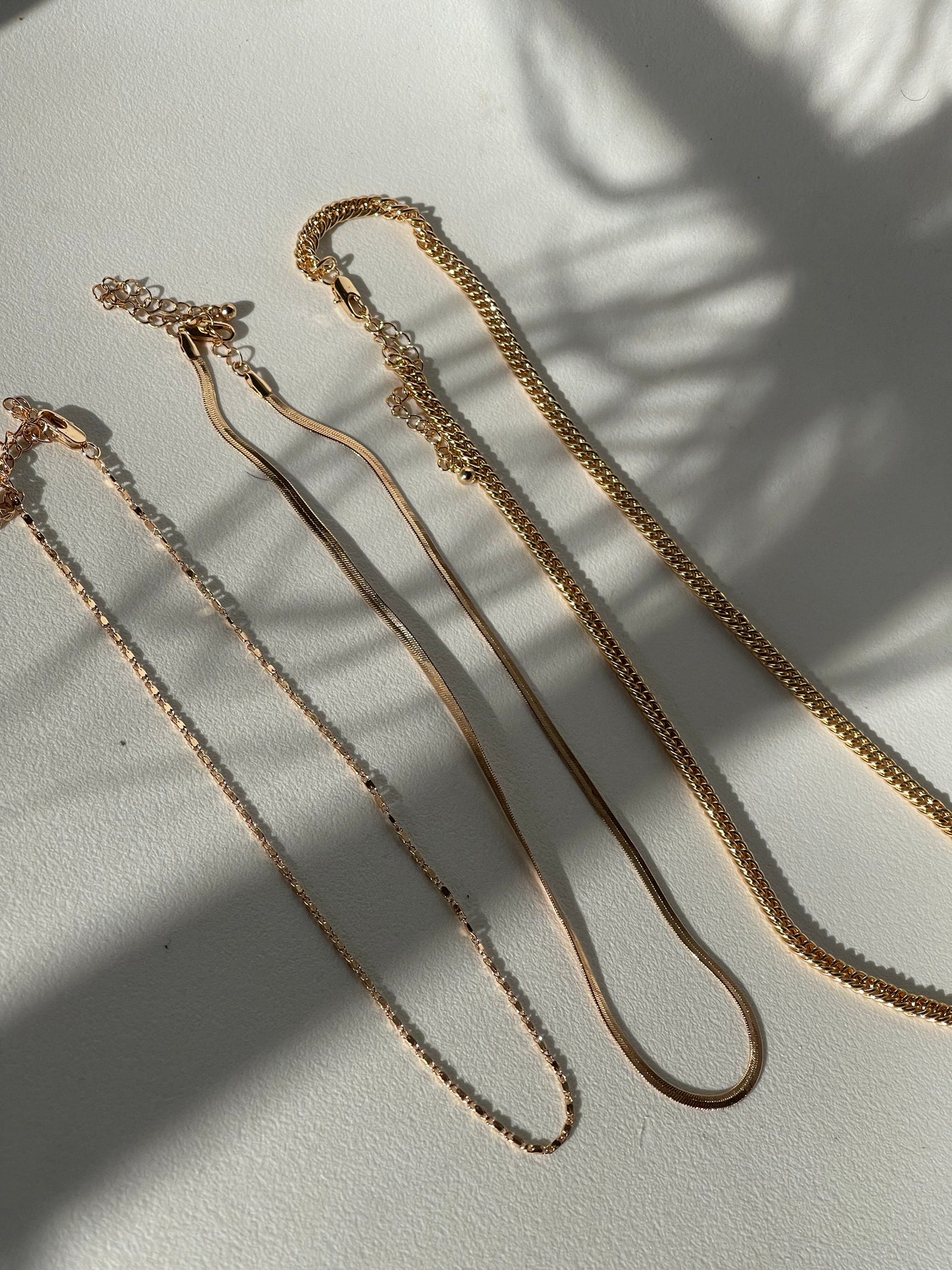 Liz Stainless Steel Tri Layered Necklace Set In Gold