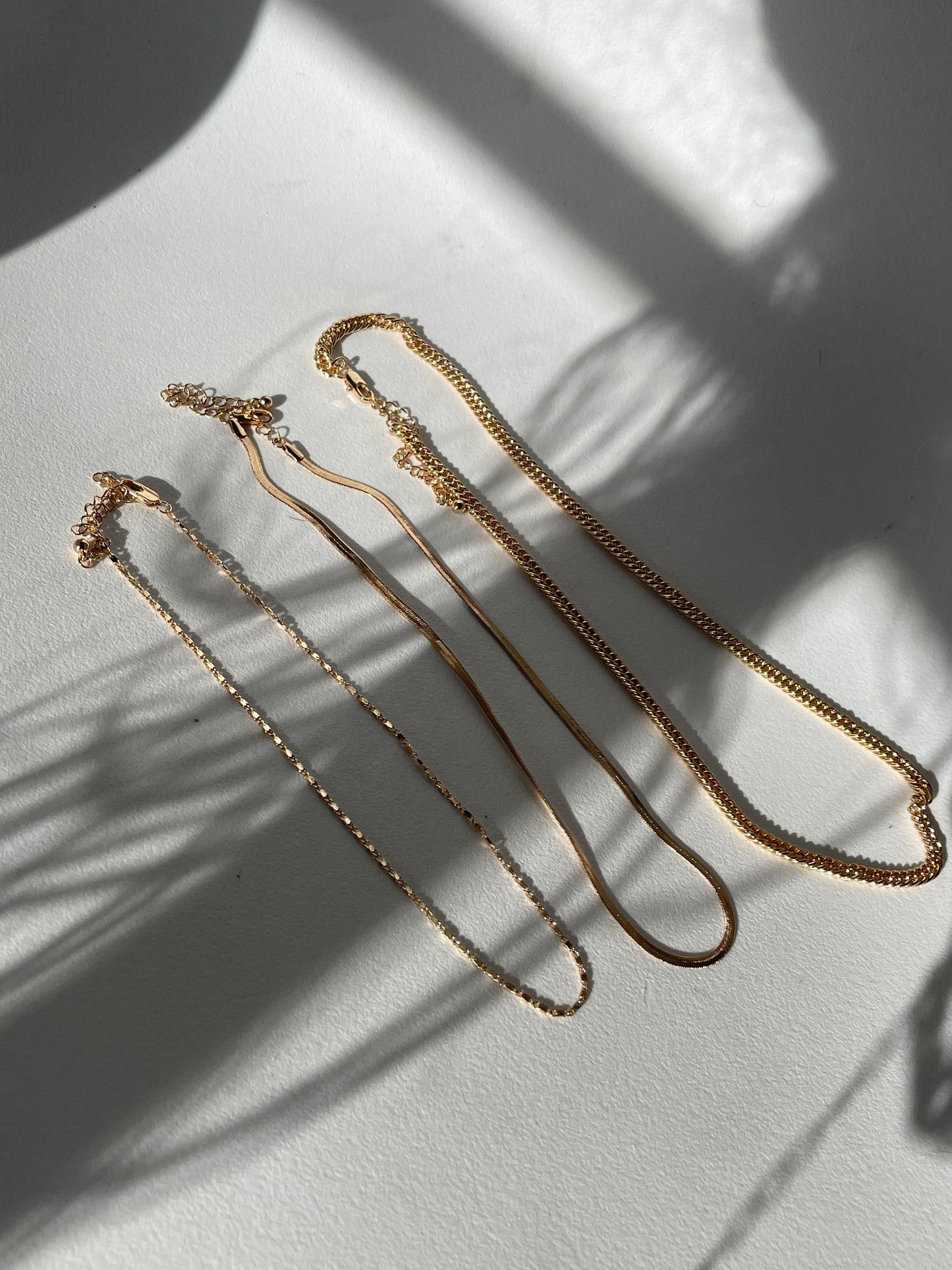 Liz Stainless Steel Tri Layered Necklace Set In Gold