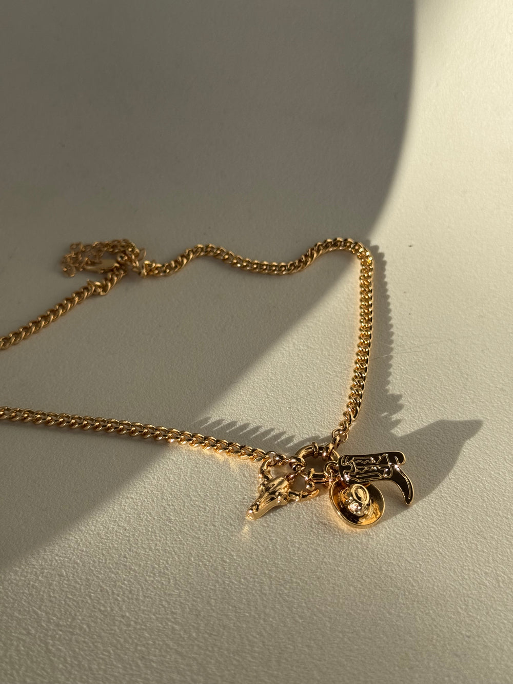 Delilah Hat Boot & Skull Charm Necklace In Gold