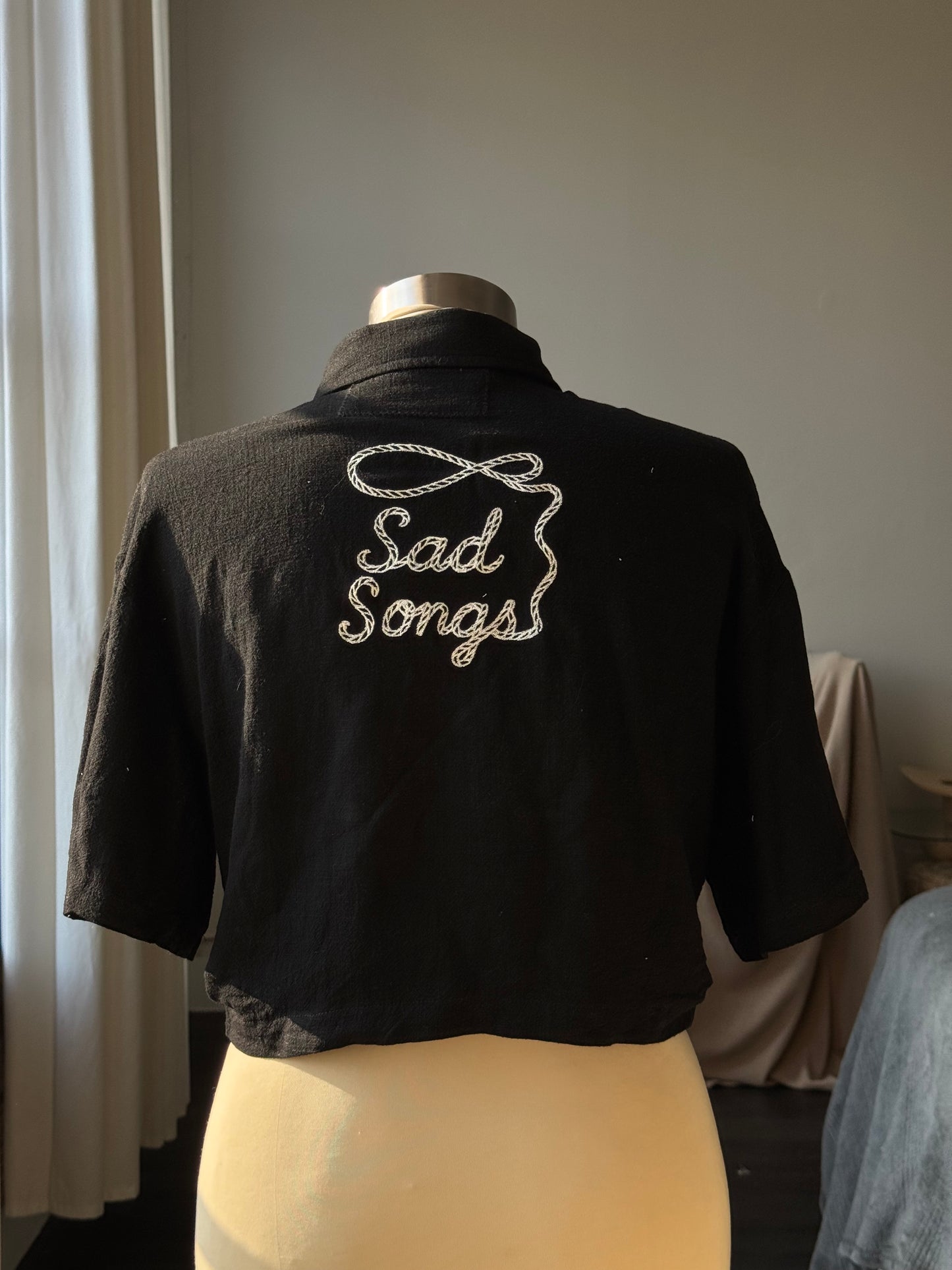 Judy Handcrafted Embroidered Sad Songs Cropped Button Down In Black