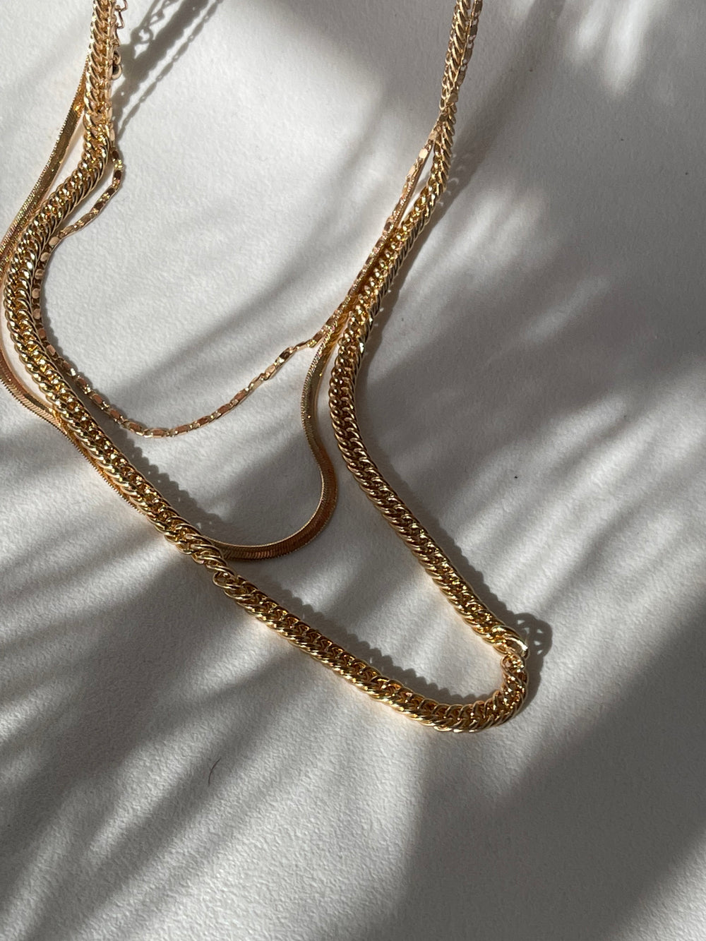 Liz Stainless Steel Tri Layered Necklace Set In Gold