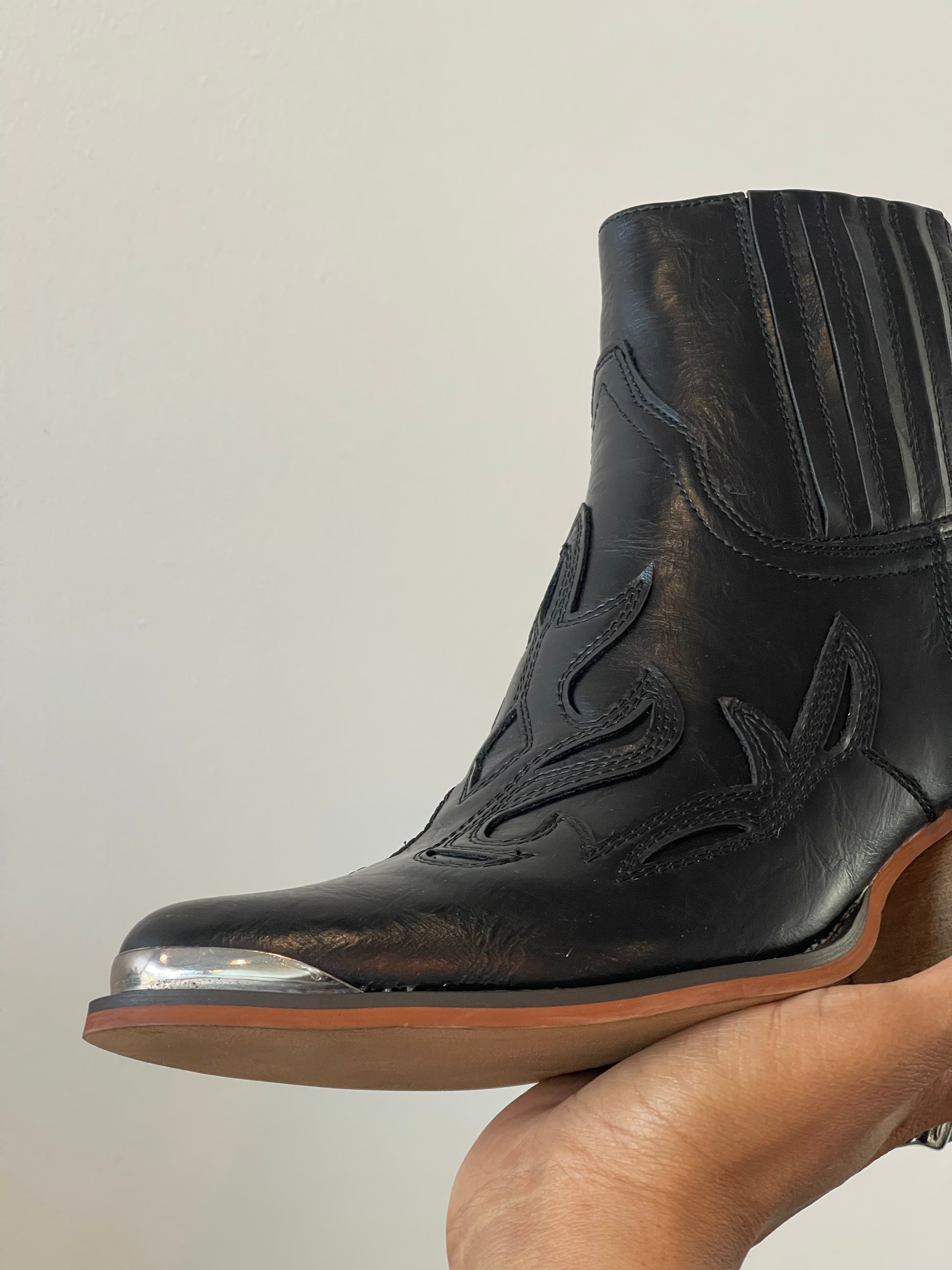 Black cowboy boots shop with silver tips